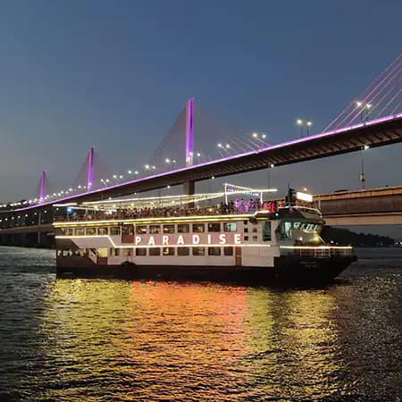 Paradise cruise ship at night with lights